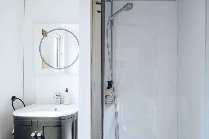 Bathroom with hot shower, sink and flushing toilet