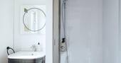 Bathroom with hot shower, sink and flushing toilet