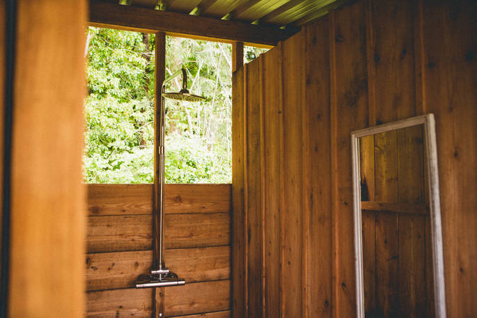The shower with views of the trees at The Farm Camp in Wiltshire