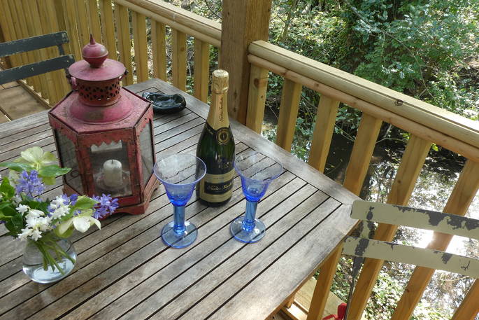 Have a spot of champagne on the decking at Hazel Tree Cabin in Buckinghamshire