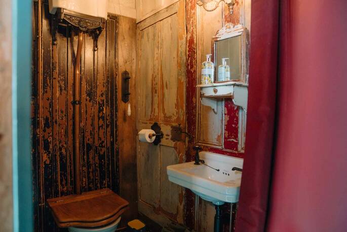 Flushing toilet and hot shower in the bathroom