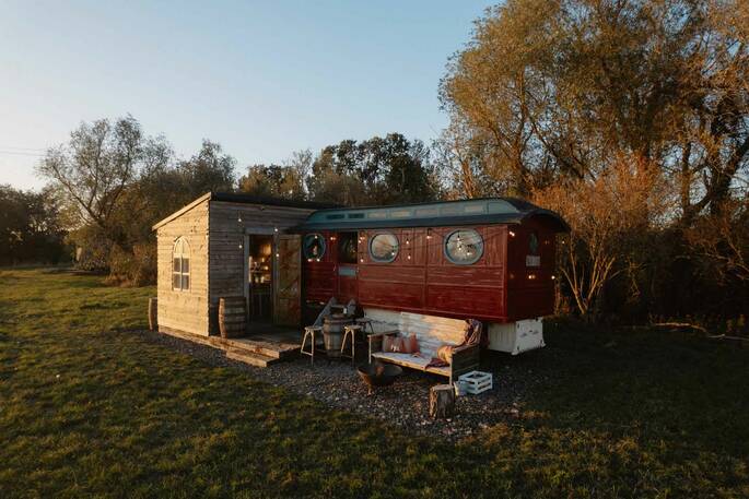 Front exterior showing the outdoor seating and firepit area