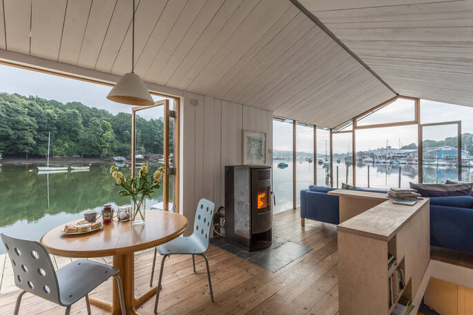 Interior living space of barge Amelie near Falmouth in Cormwall with panoramic river views 
