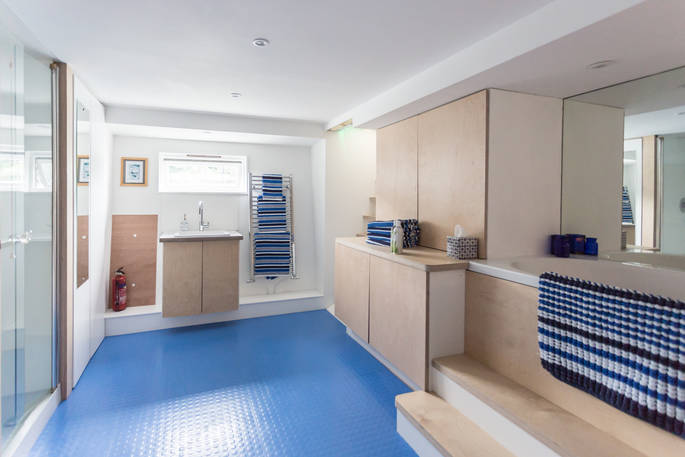The family-size bathroom below deck with shower, double-ended bath and wash basin 