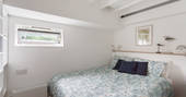 The smaller double cabin below deck with king-size bed aboard Amelie in Cornwall 