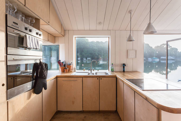 Well-equipped kitchen on-board Amelie in Cornwall with view of neighbouring boats