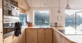 Well-equipped kitchen on-board Amelie in Cornwall with view of neighbouring boats