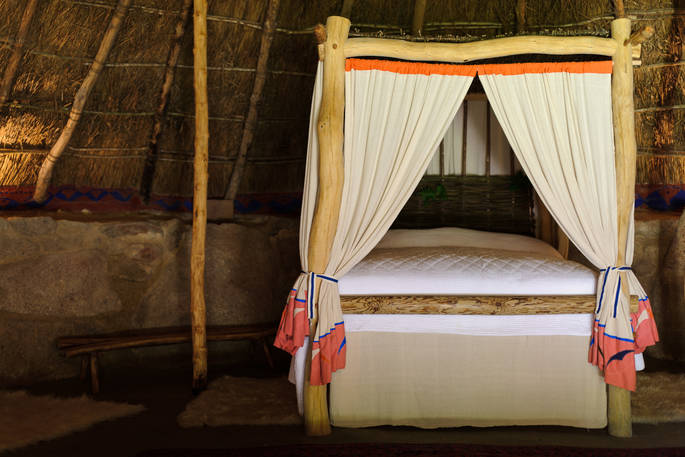 The huge comfy four poster bed inside The Roundhouse in Cornwall