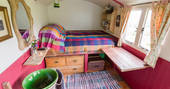 Your perfect slice of bedroom space, with a raised bed and space to sit by the log burner at Diddylake in Cornwall