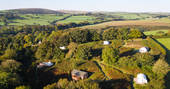Aerial view of all the spaces at Ekopod in Cornwall with stunning views of the surrounding fields 