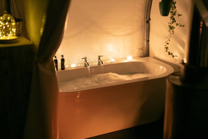 Steren pod bathtub during the night with candles at Ekopod, Launceston, Cornwall