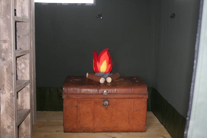 Vintage trunk with pretend fire cushion inside of the Safari Tent