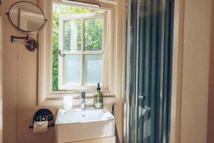 16 - Bathroom with a hot shower, sink and toilet