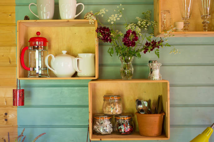 Close up of wooden shelves with kitchen utensils 