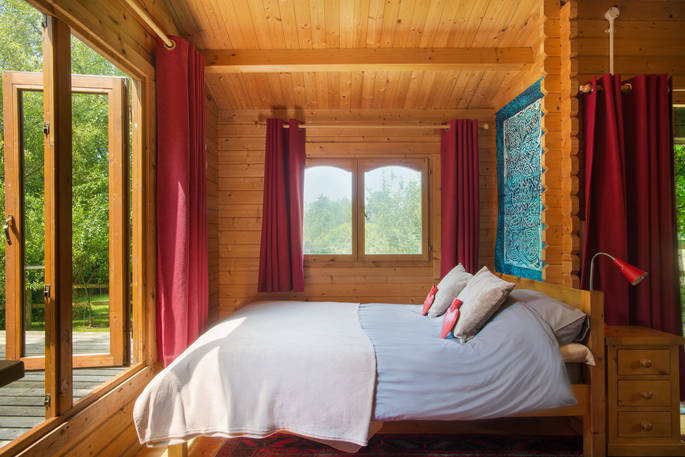 Interior of cosy double bed facing large open windows