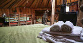 The bed laden with fresh towels at Cornish Hobbit in Cornwall