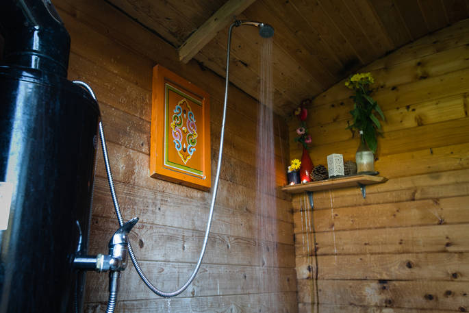 The wooden clad shower hut at Mill Valley Farm in Cornwall