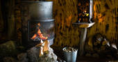 Roaring fire in the wood burner inside of The Stumpy Hobbit at Mill Valley
