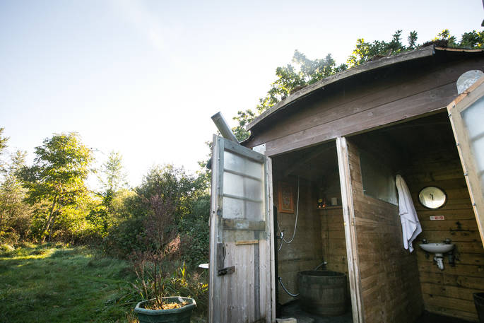 Shared showers in wooden shed for guests of Mill Valley 