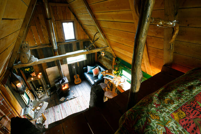 View of downstairs from the mezzanine level inside of Woodland cabin at Mill Valley in Cornwall 