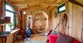An interior view of the cosy wood crafted Woodland Hobbit cabin in Cornwall