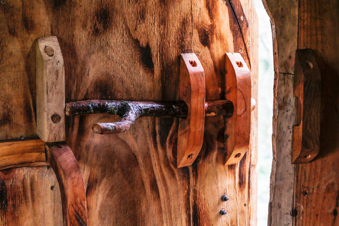 The creative wood-crafted door lock at Woodland Hobbit in Cornwall