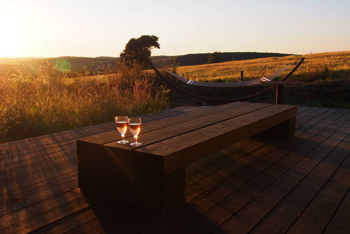 A gorgeous day draws to a close at Quiet of Stars cabin, the sunset lights the beautiful wooden deck, on which a long wooden table stands with two delicious glasses of rose. Just off the decking is a comfortable double hammock overlooking the stunning Cornwall countryside