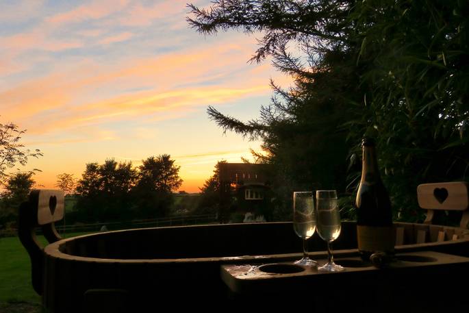 Relax in the wood fired hot tub as you watch the sunset at Sangers Showman's Wagon in Cornwall