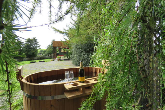 Relax in the wood-fired hot tub at Sangers Showmans Wagon in Cornwall