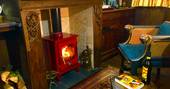 Sit by the fire with a glass of red wine at Sanger's Showman's Wagon in Cornwall