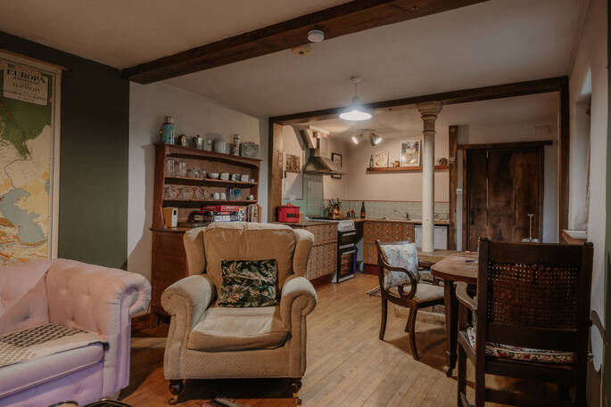 Open plan layout with a kitchen equipped with an oven, stove and all cooking utensils