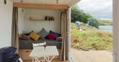 scandi cabin shipping container interior woodburner french doors with private lake view cornwall 