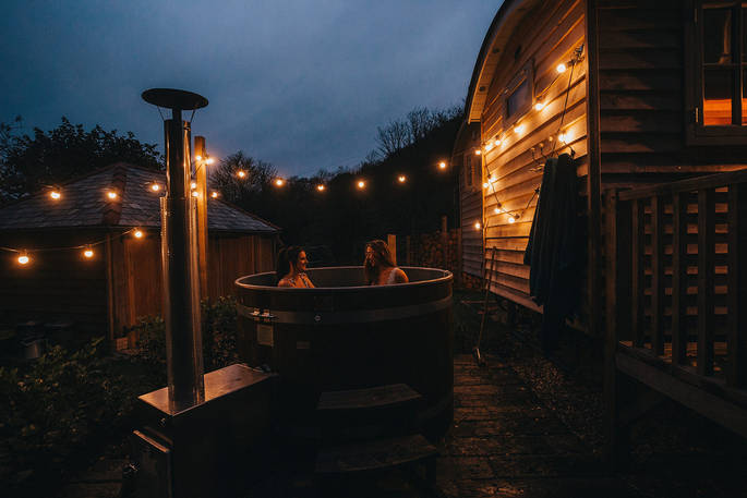 Wilderness Kitchen shepherds hut - the hot tub during the night with fairy lights, St Agnes, Cornwall