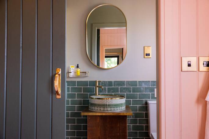 Bathroom with a hot shower, sink and flushing toilet