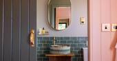 Bathroom with a hot shower, sink and flushing toilet