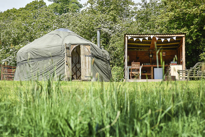 Croglin Yurt and outdoor covered kitchen and seating area at Drybeck Farm in Cumbria