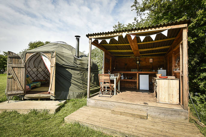 Croglin Yurt with outdoor covered kitchen and seating area at Drybeck Farm in Cumbria