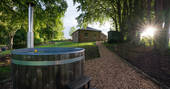 Cuckoo Cottage hot tub with view to the cottage, Edenhall Estate, Penrith, Cumbria