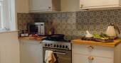 Kitchen equipped with an oven, microwave and electric hob