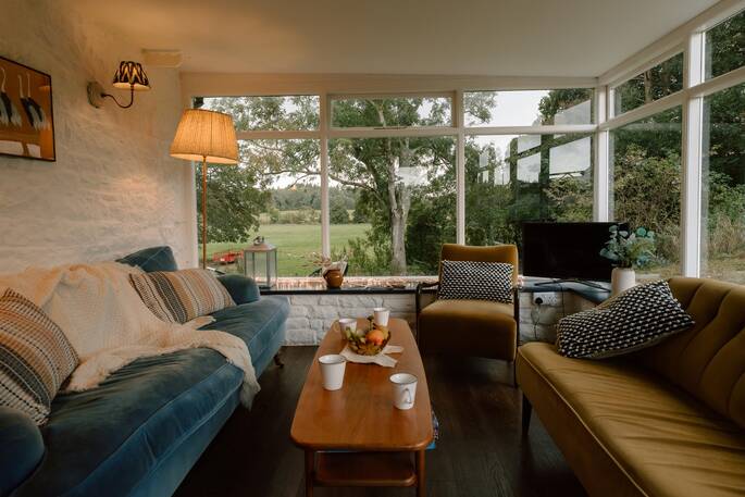 Living room with sofa and view onto the garden