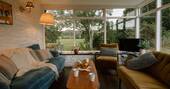 Living room with sofa and view onto the garden