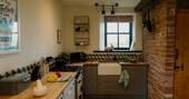 Kitchen equipped with an oven, microwave, electric hob