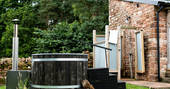 Try some outdoor bathing with the private wood-fired hot tub or outdoor shower, at The Bothy at High Barn in Cumbria