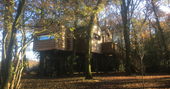 Autumnal view of the exterior of Faraway Treehouse in Cumbria
