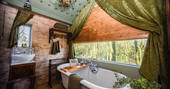 Relax and soak in the roll top bath tub looking out over Cumbria inside Faraway Treehouse