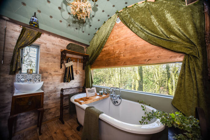 Relax and soak in the roll top bath tub looking out over Cumbria inside Faraway Treehouse