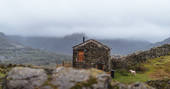 The Hog House bothy - visitor at the door, Coniston, Cumbria