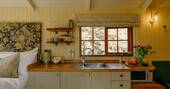 Kitchen equipped with a microwave and fridge