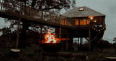 netherby treehouse at night firepit glamping england uk cumbria holiday