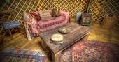 Sit and read by the cosy fire at Netherby Woodland Yurt in Cumbria